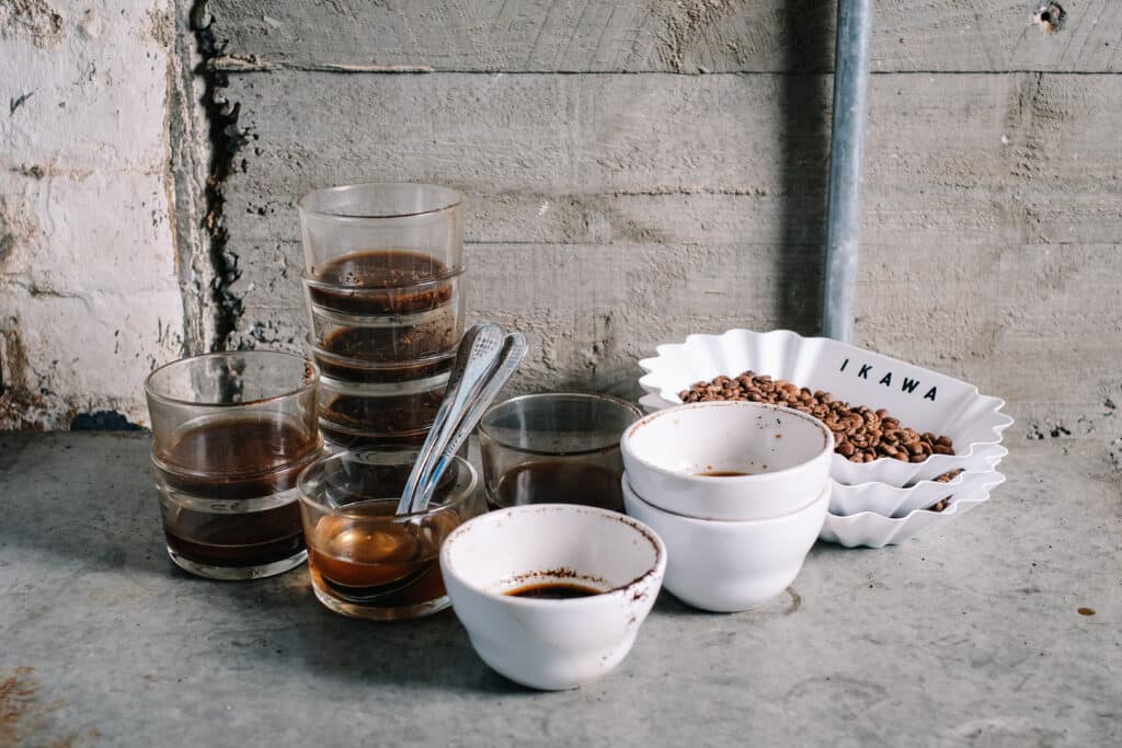 Photo of used coffee cupping equipment. The case for simplicity in sample roasting.